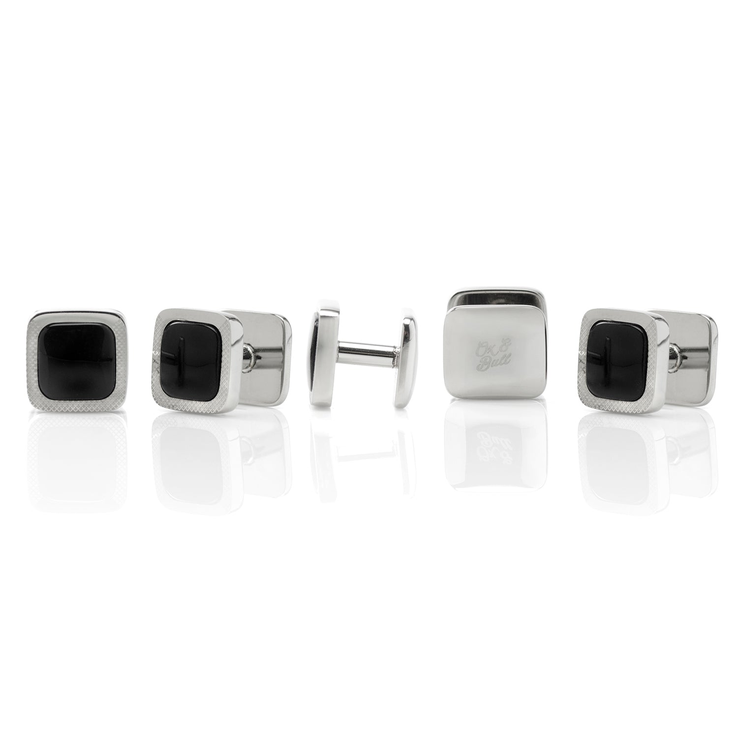 Set of silver cufflinks with black square centers on a white background
