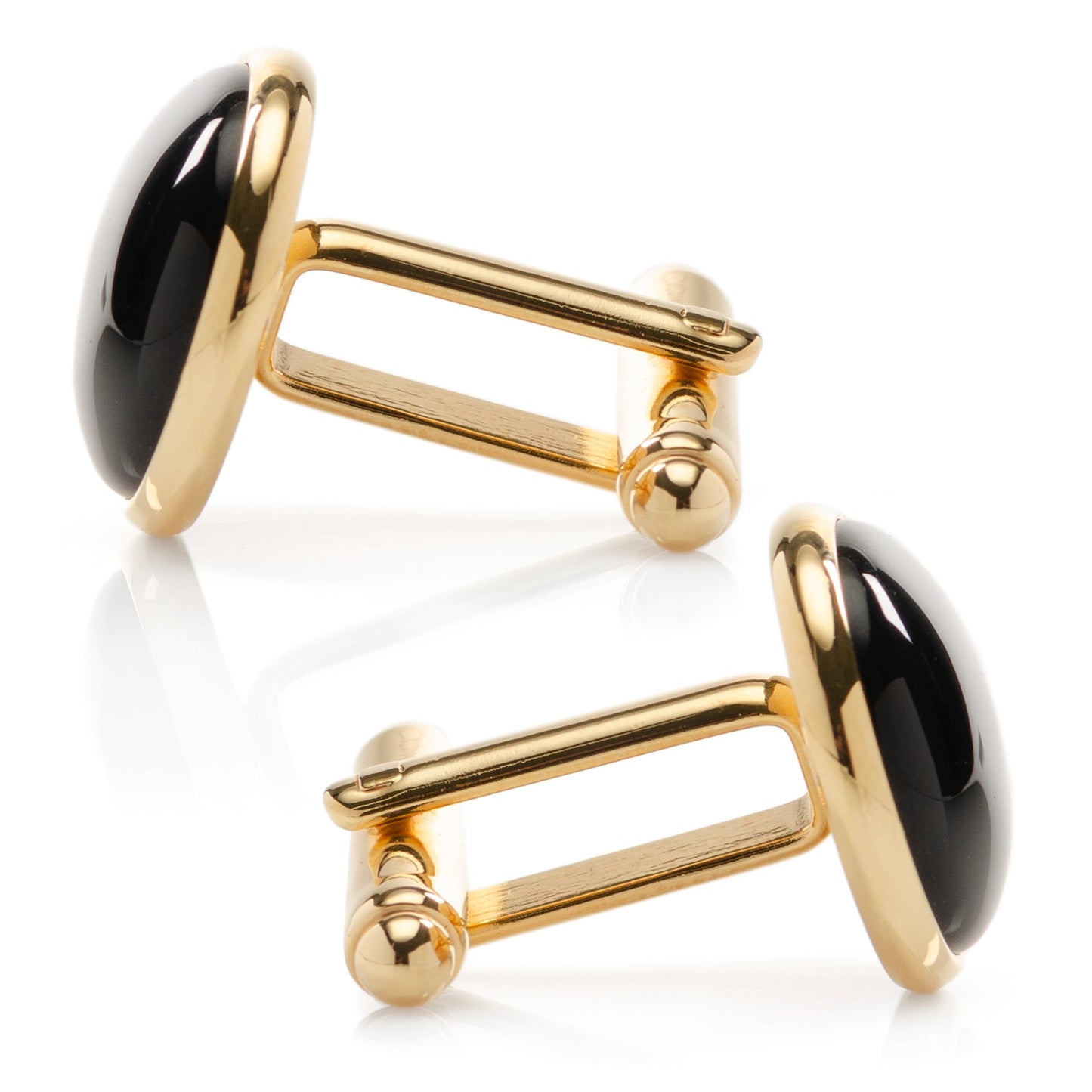 Gold cufflinks with black cabochon stones on a white background