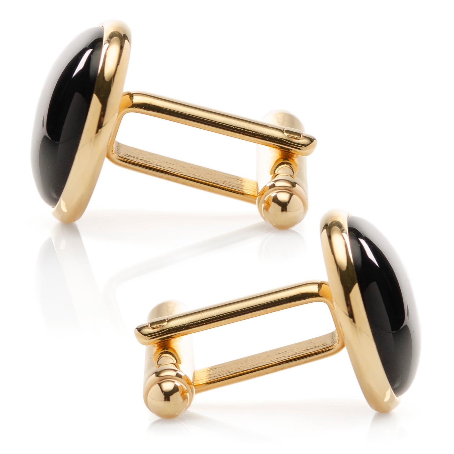 Gold cufflinks with black cabochon stones on a white background