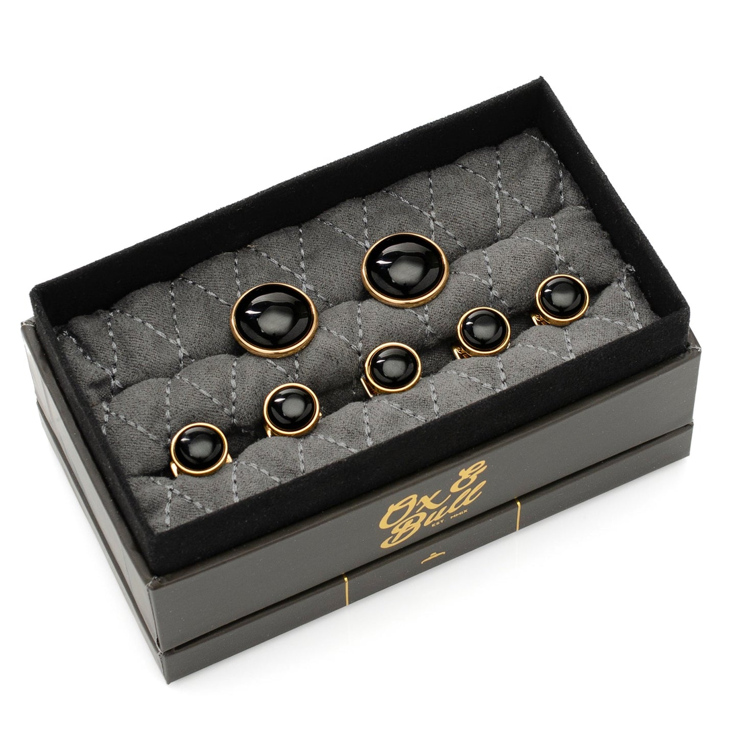 Set of black and gold cufflinks in a branded box on a white background