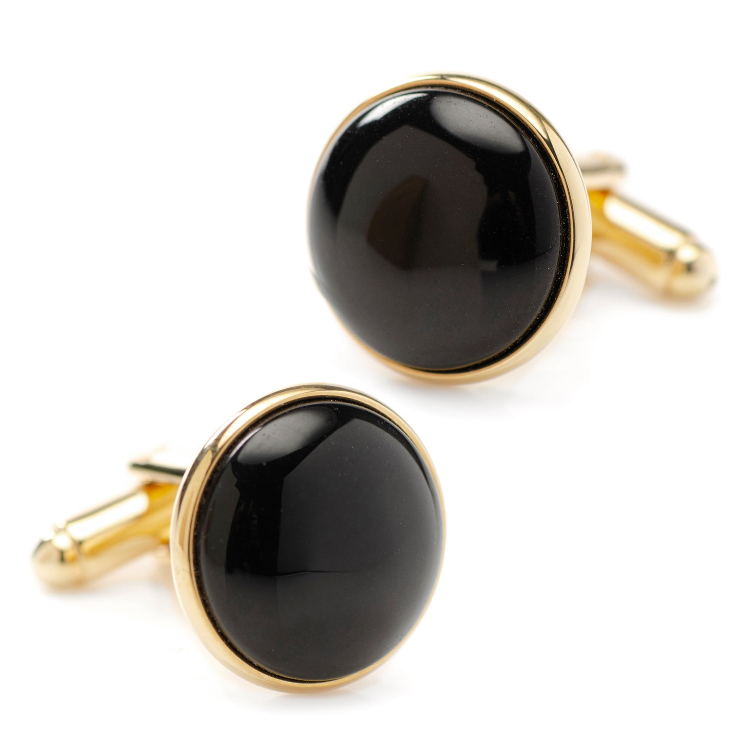 Black cufflinks with gold rims on a white background