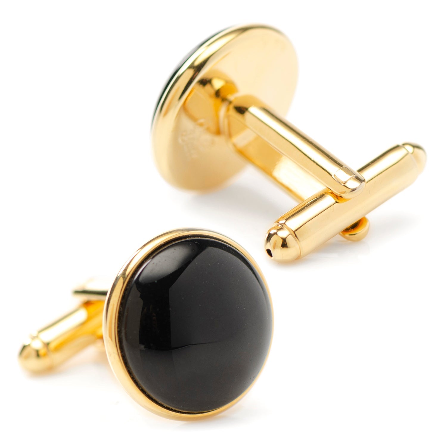Gold cufflinks with black round stones on a white background