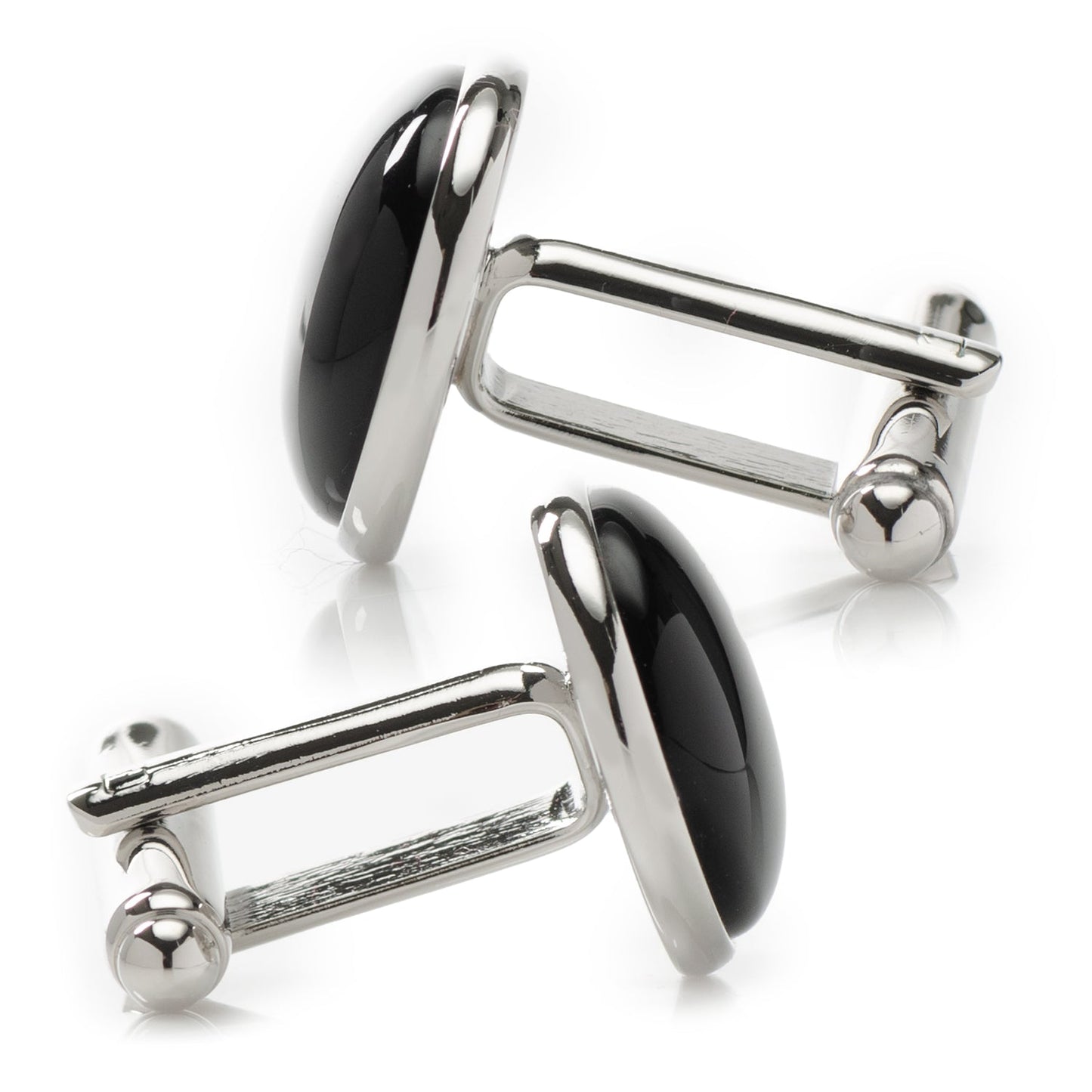 Pair of silver cufflinks with black stones on a white background