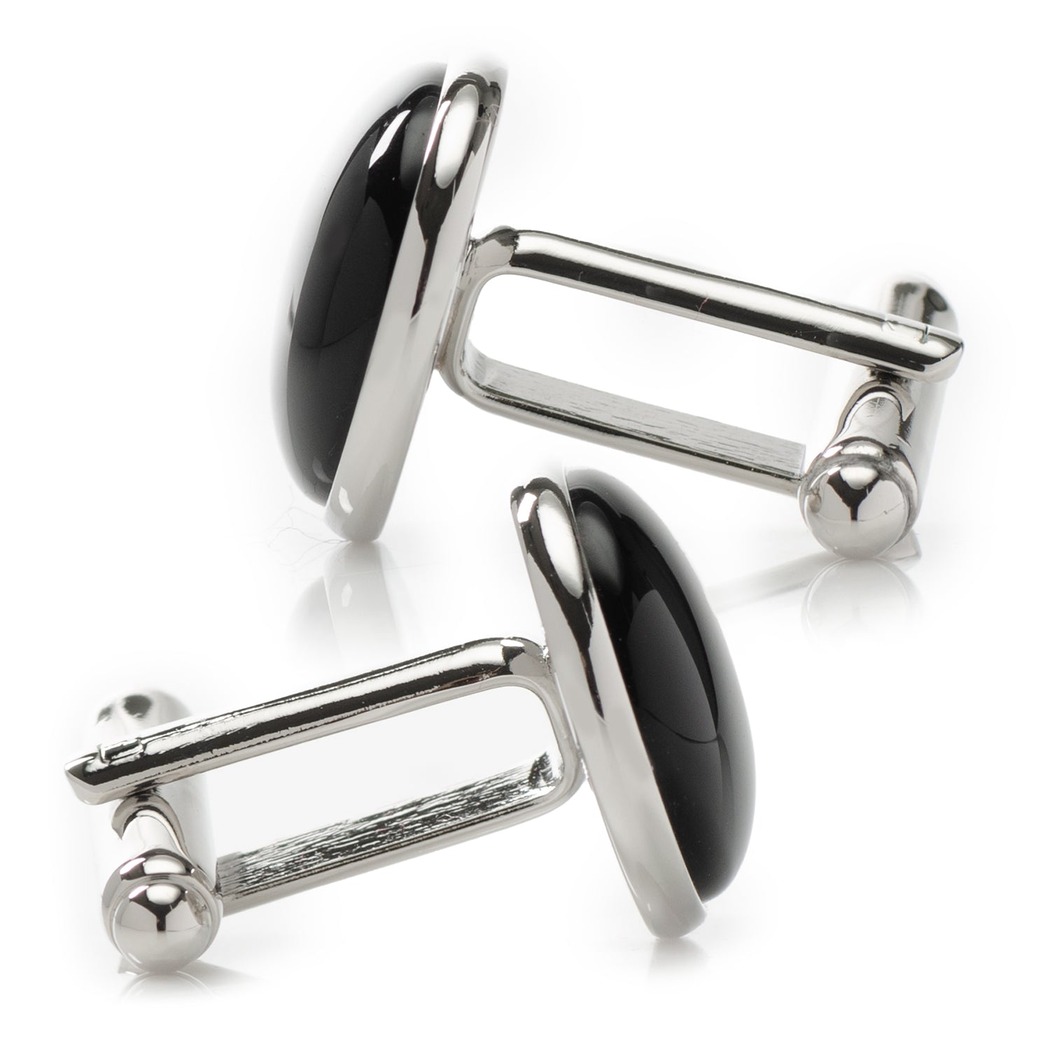 Pair of silver cufflinks with black stones on a white background
