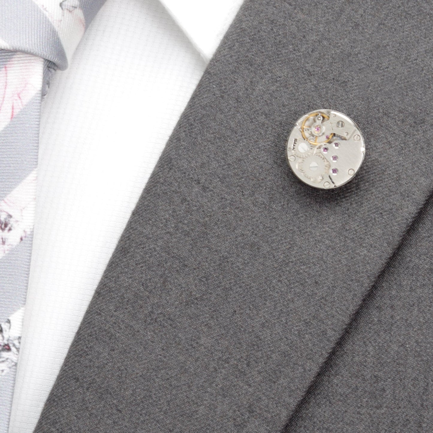 Close-up of a decorative button on a gray fabric background