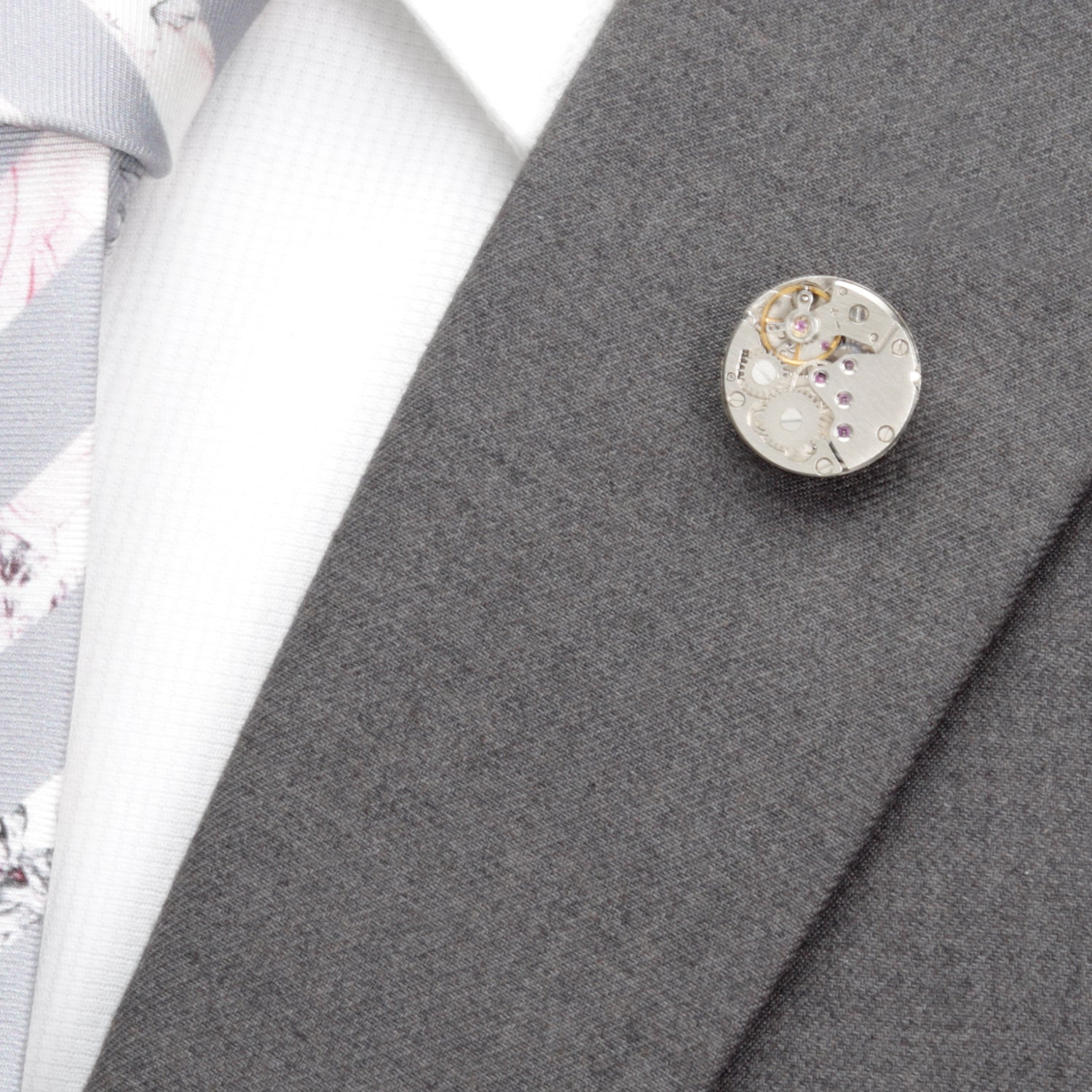 Close-up of a decorative button on a gray fabric background