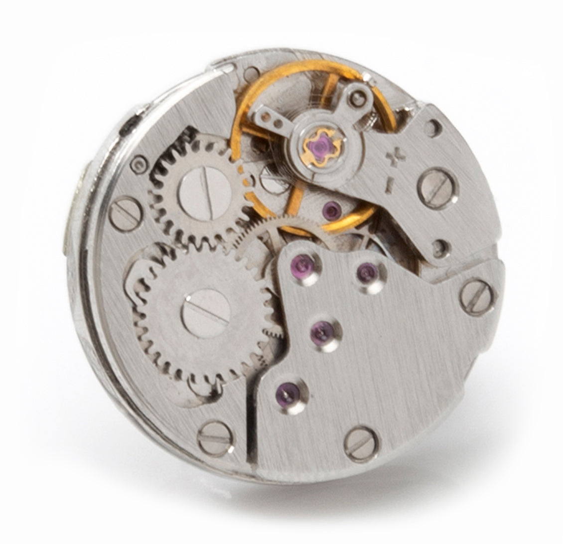 Close-up of a mechanical watch movement on a white background
