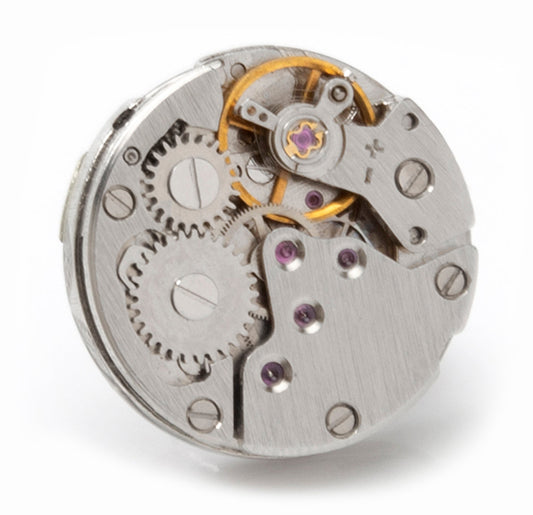 Close-up of a mechanical watch movement on a white background