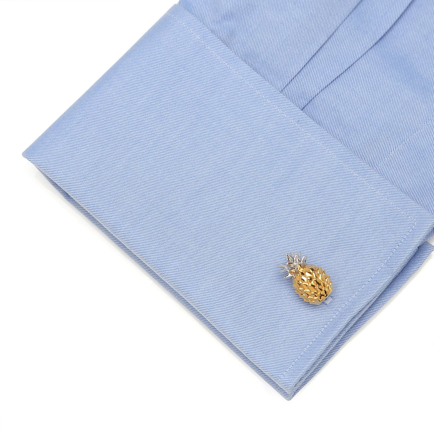 Gold pineapple cufflink on a light blue dress shirt