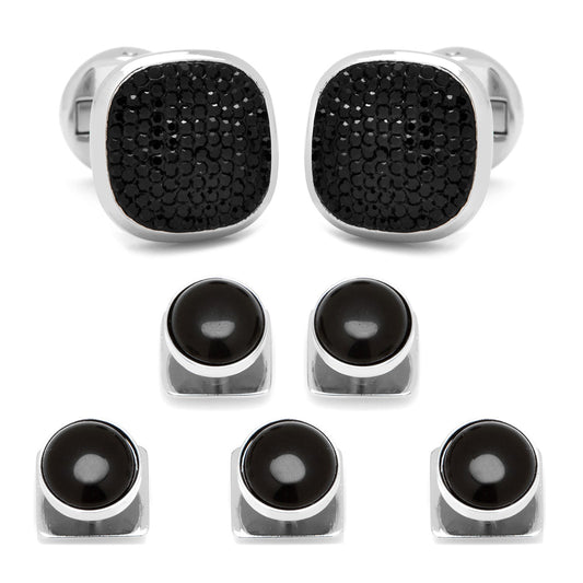 Set of black and silver cufflinks on a white background