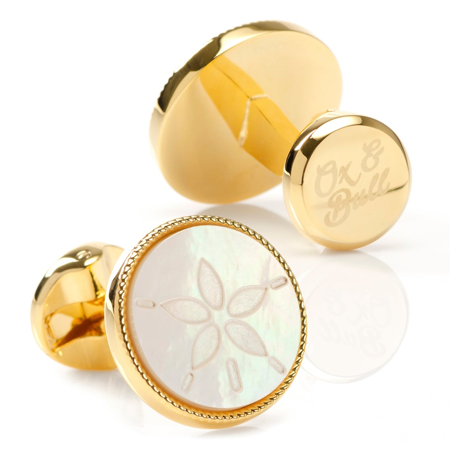Gold cufflinks with a floral design on a white background