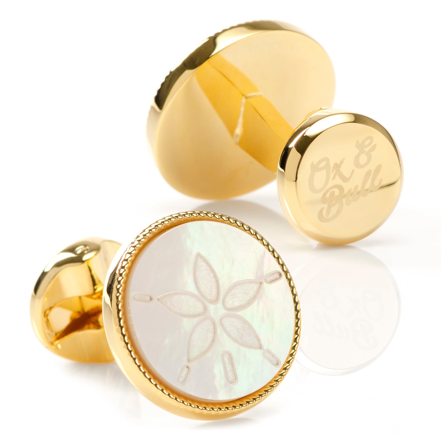 Gold cufflinks with a floral design on a white background