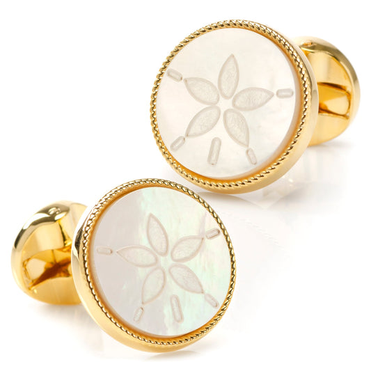 Gold cufflinks with floral engraving on a white background