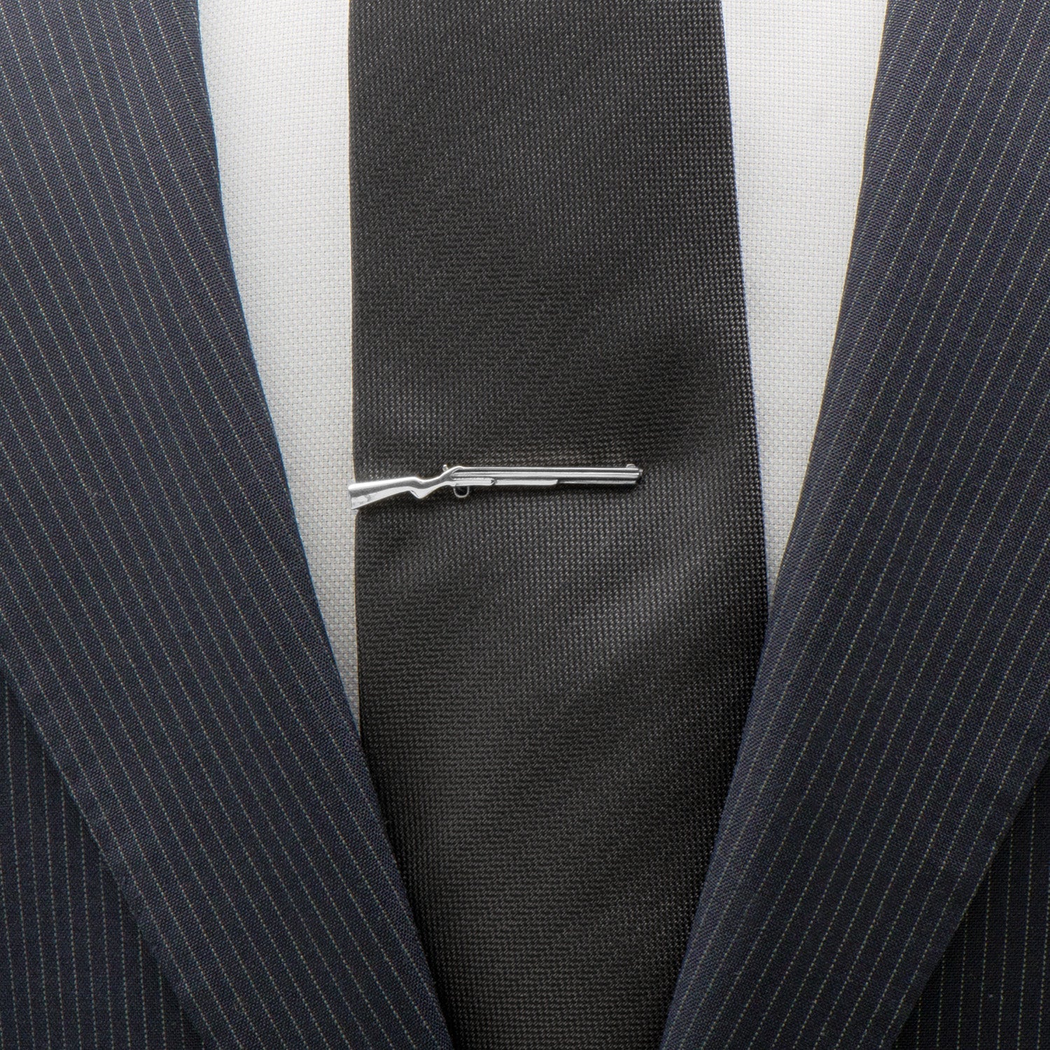 Close-up of a suit with a tie clip on a white background