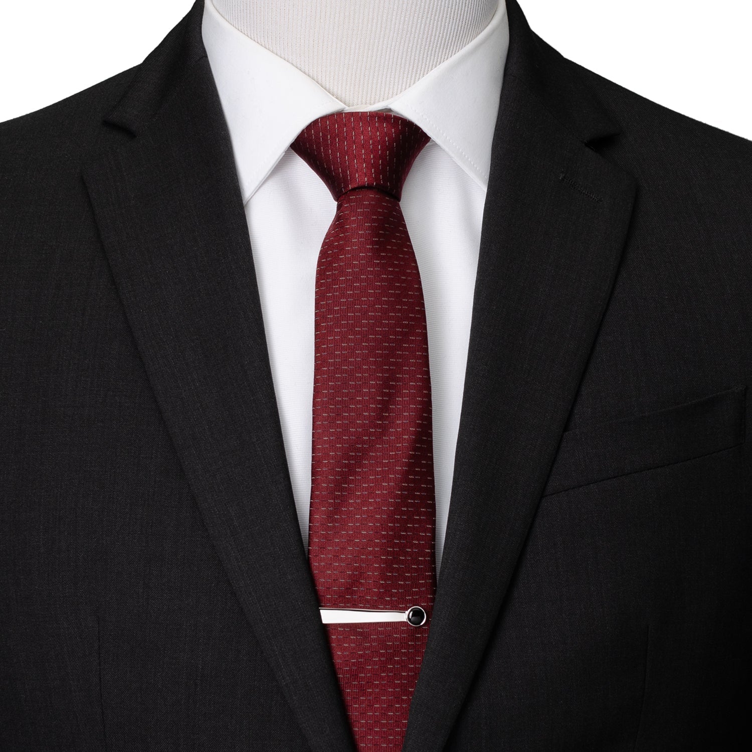 Mannequin wearing a black suit with a white shirt and red tie.