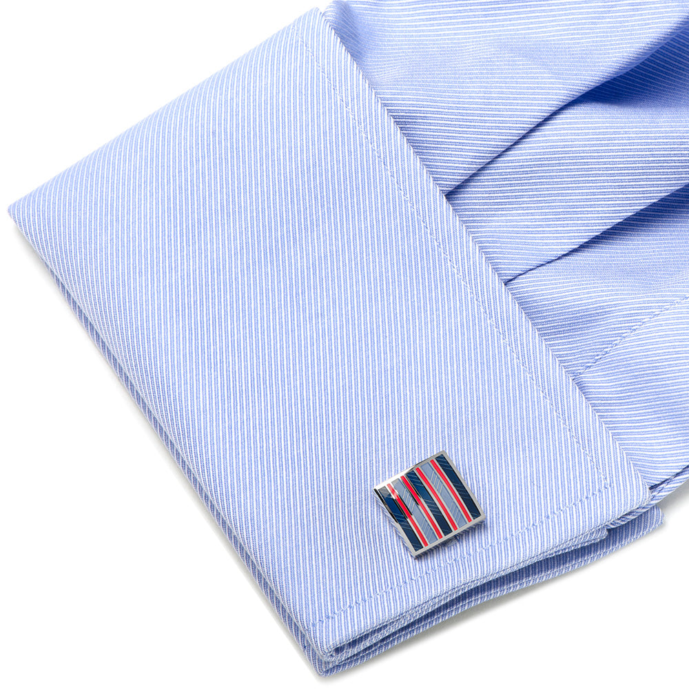 Cufflink on a folded blue striped shirt