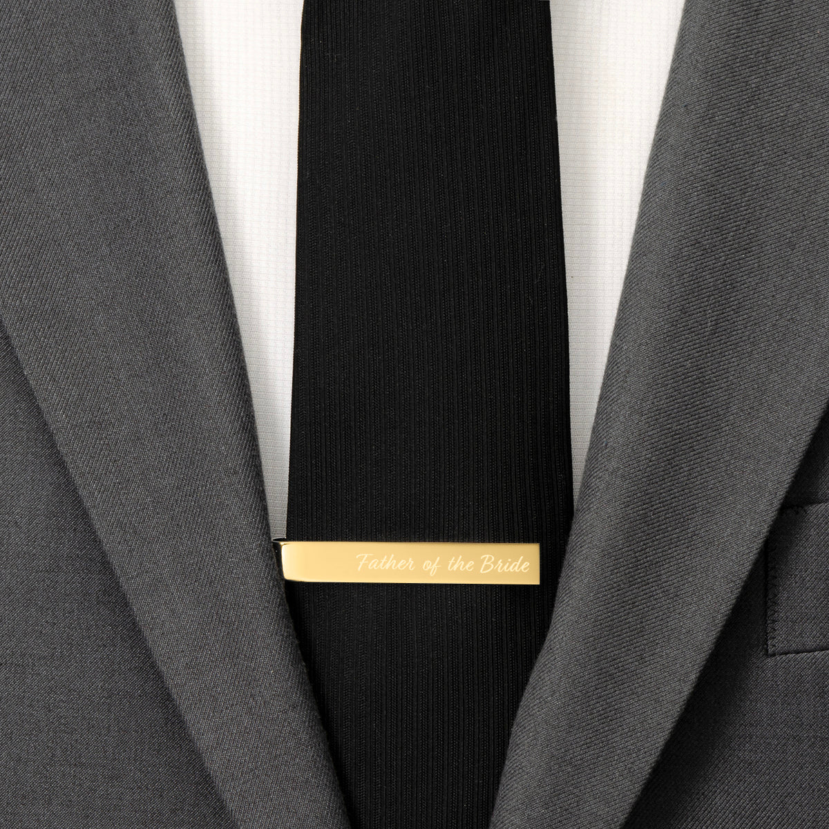 Black tie with a gold bar and 'Groom of the Bride' text on a gray suit jacket.