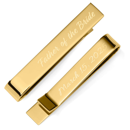 Two gold tie clips with engraved text on a white background