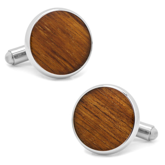 Wooden cufflinks with silver metal rims on a white background
