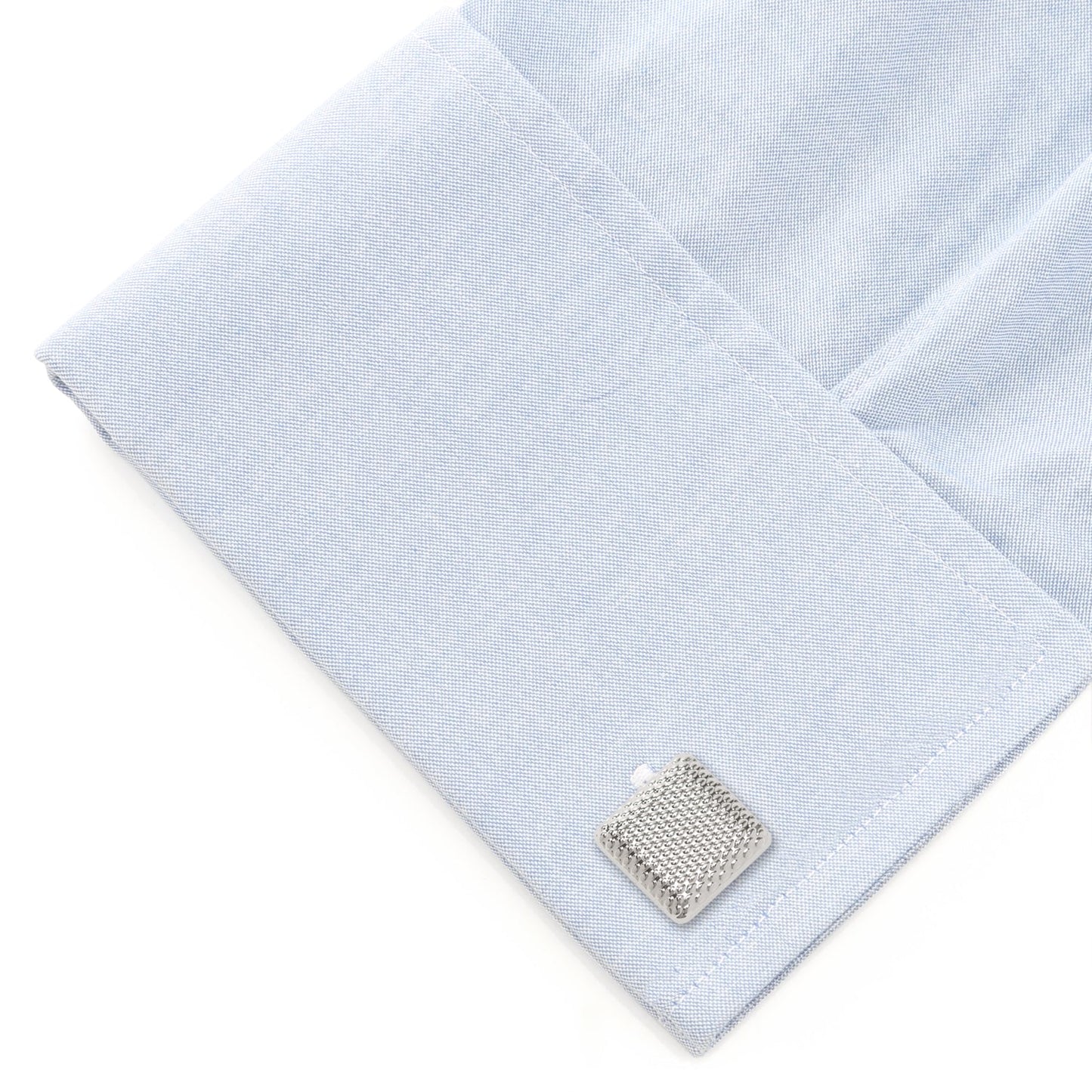 Light blue pocket square with a silver cufflink on a white background