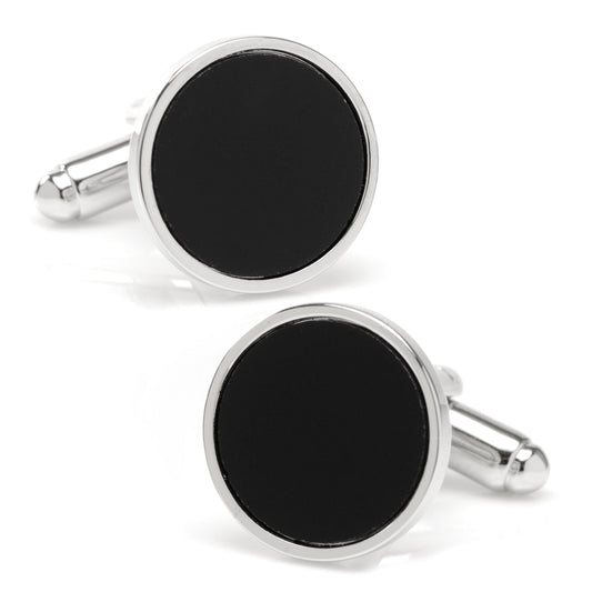 Round black cufflinks with silver borders on a white background