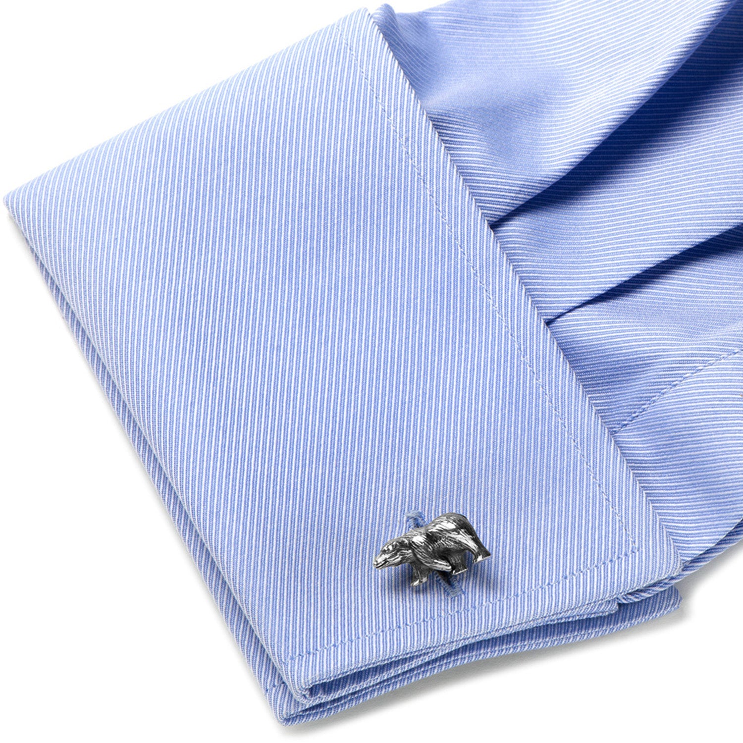 Silver bear cufflink on a blue striped shirt