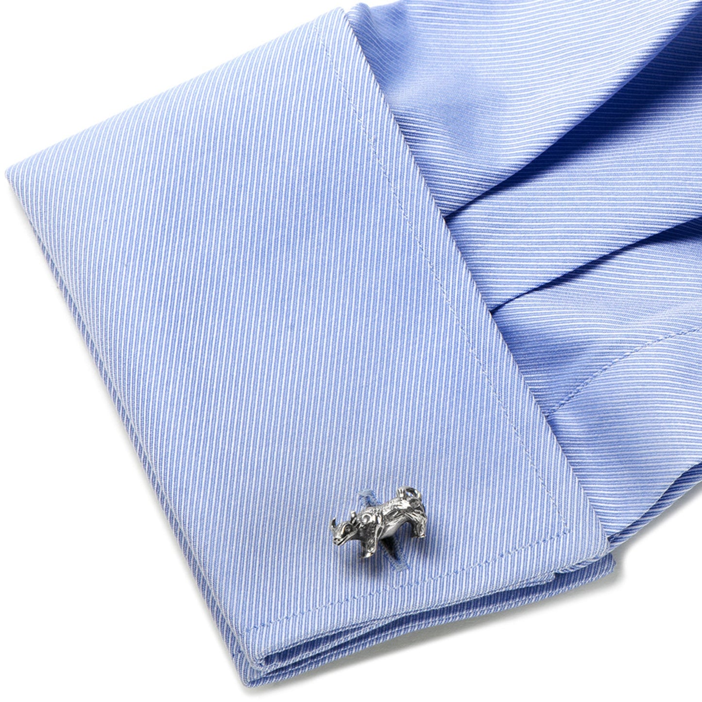 Silver bear-shaped cufflink on a blue striped shirt