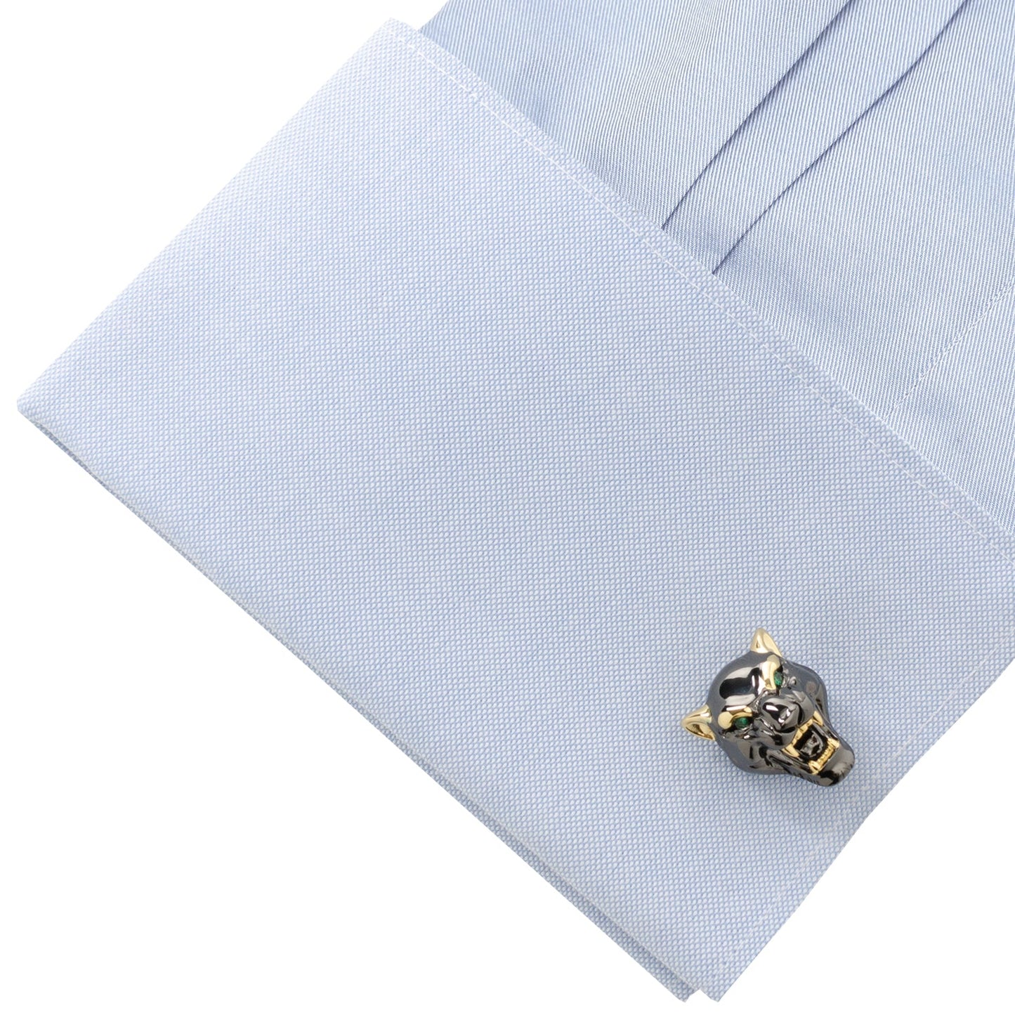 Skull-shaped cufflinks on a light blue shirt
