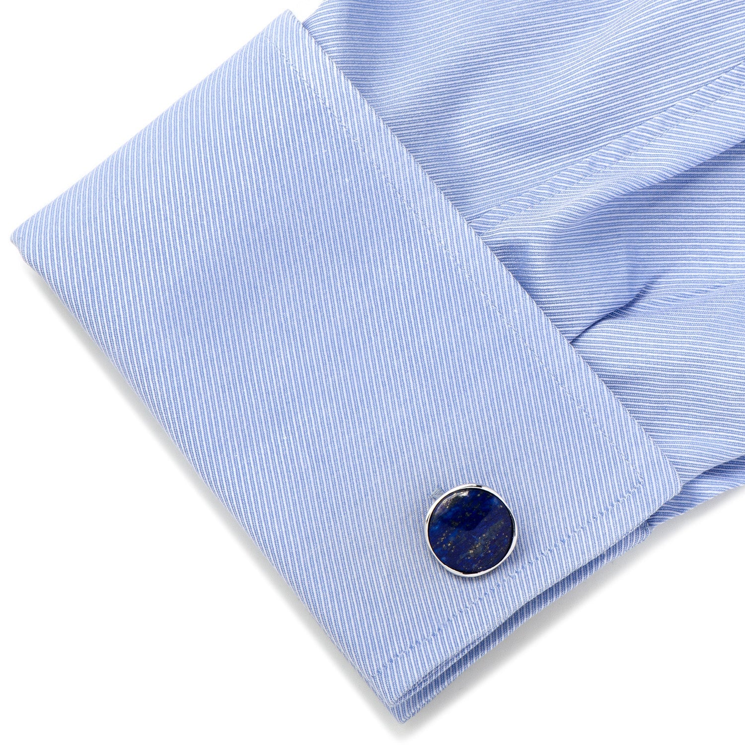 Close-up of a blue striped shirt cuff with a round cufflink on a white background