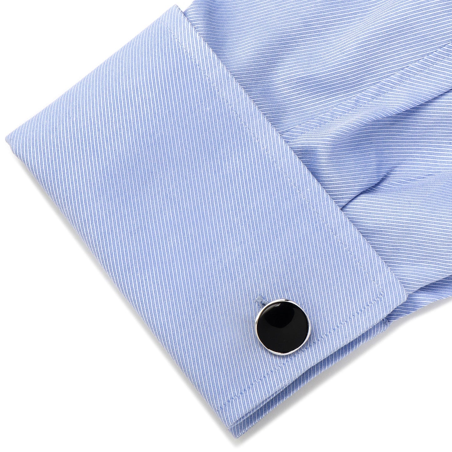Close-up of a blue striped shirt cuff with a black cufflink on a white background