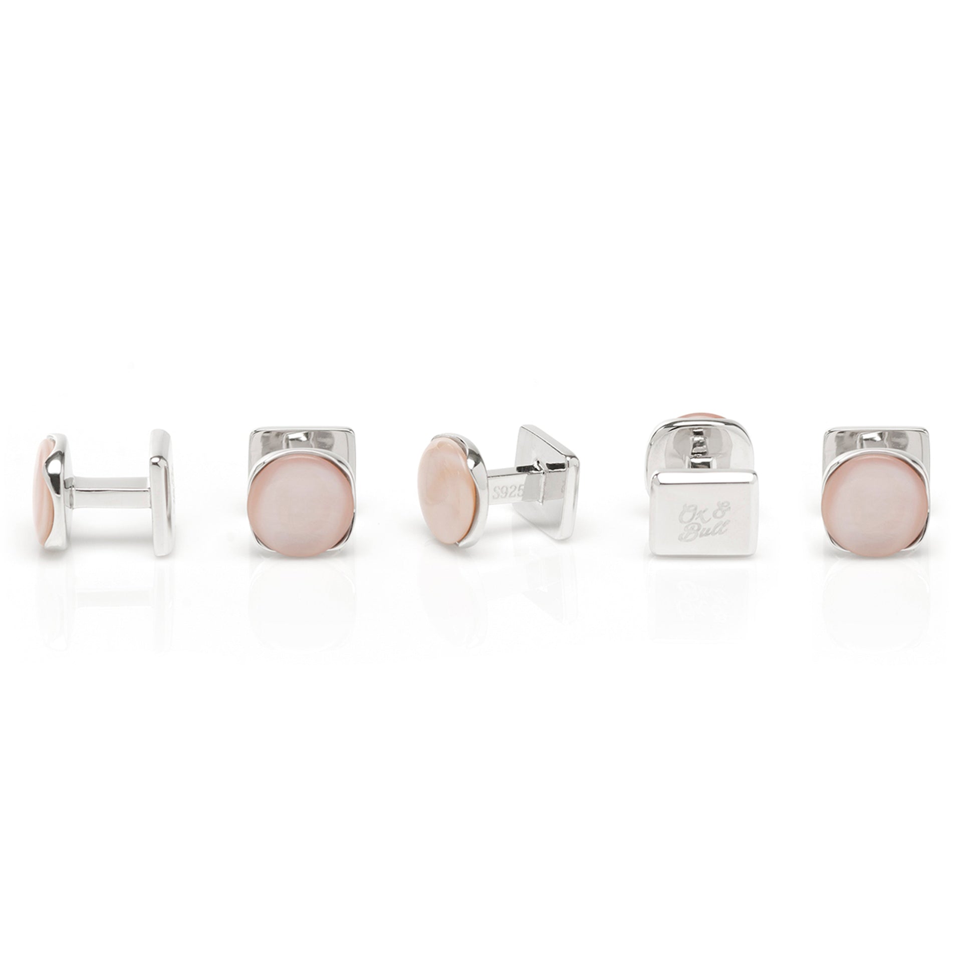Set of silver and rose gold cufflinks on a white background