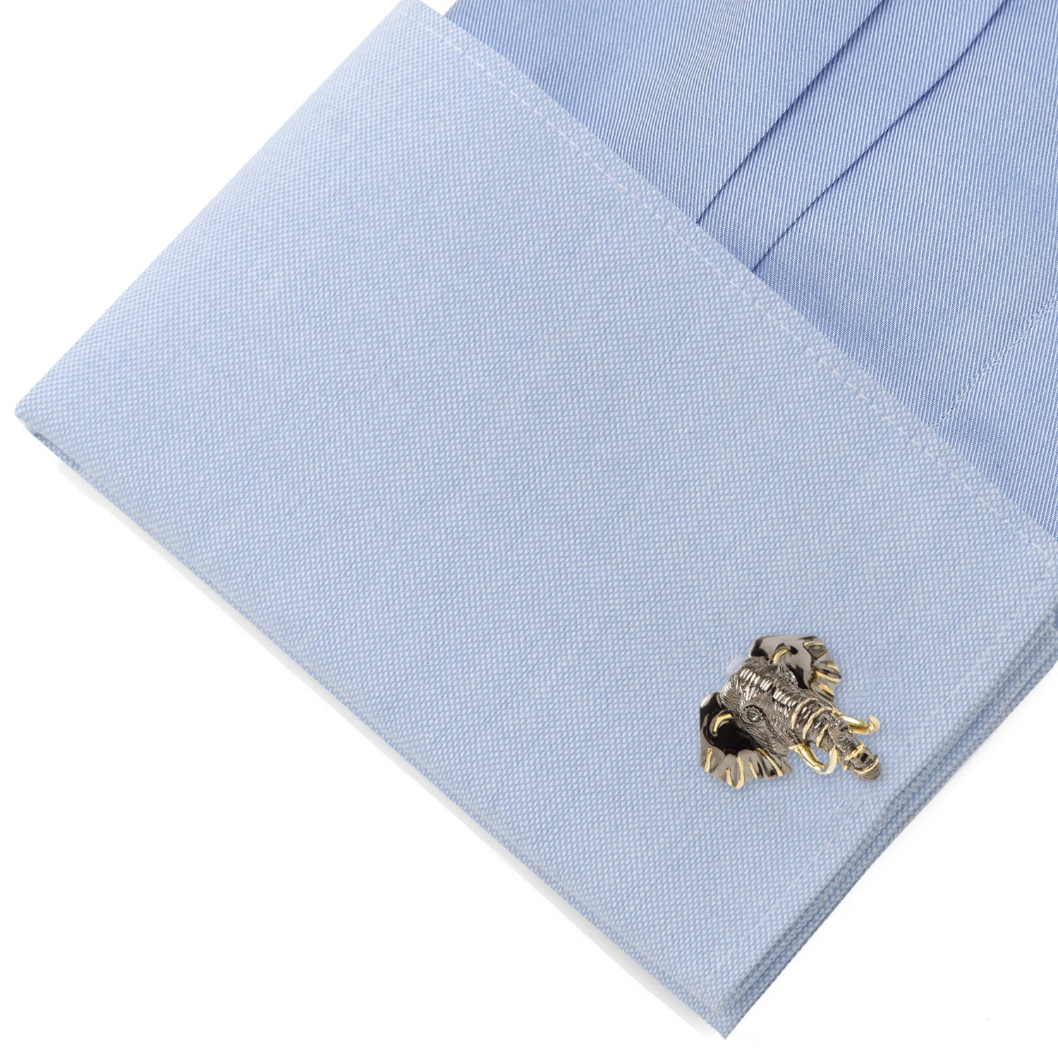 Gold cufflinks on a light blue dress shirt