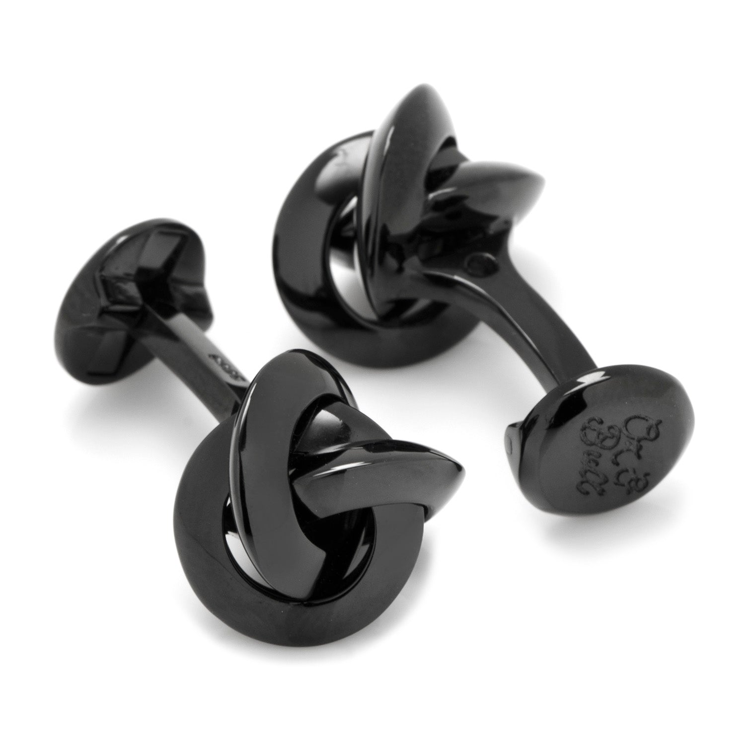 Black knot-shaped cufflinks on a white background