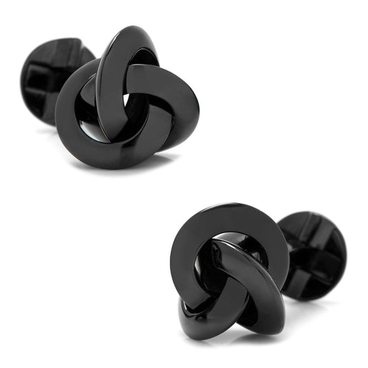 Black knot-shaped cufflinks on a white background
