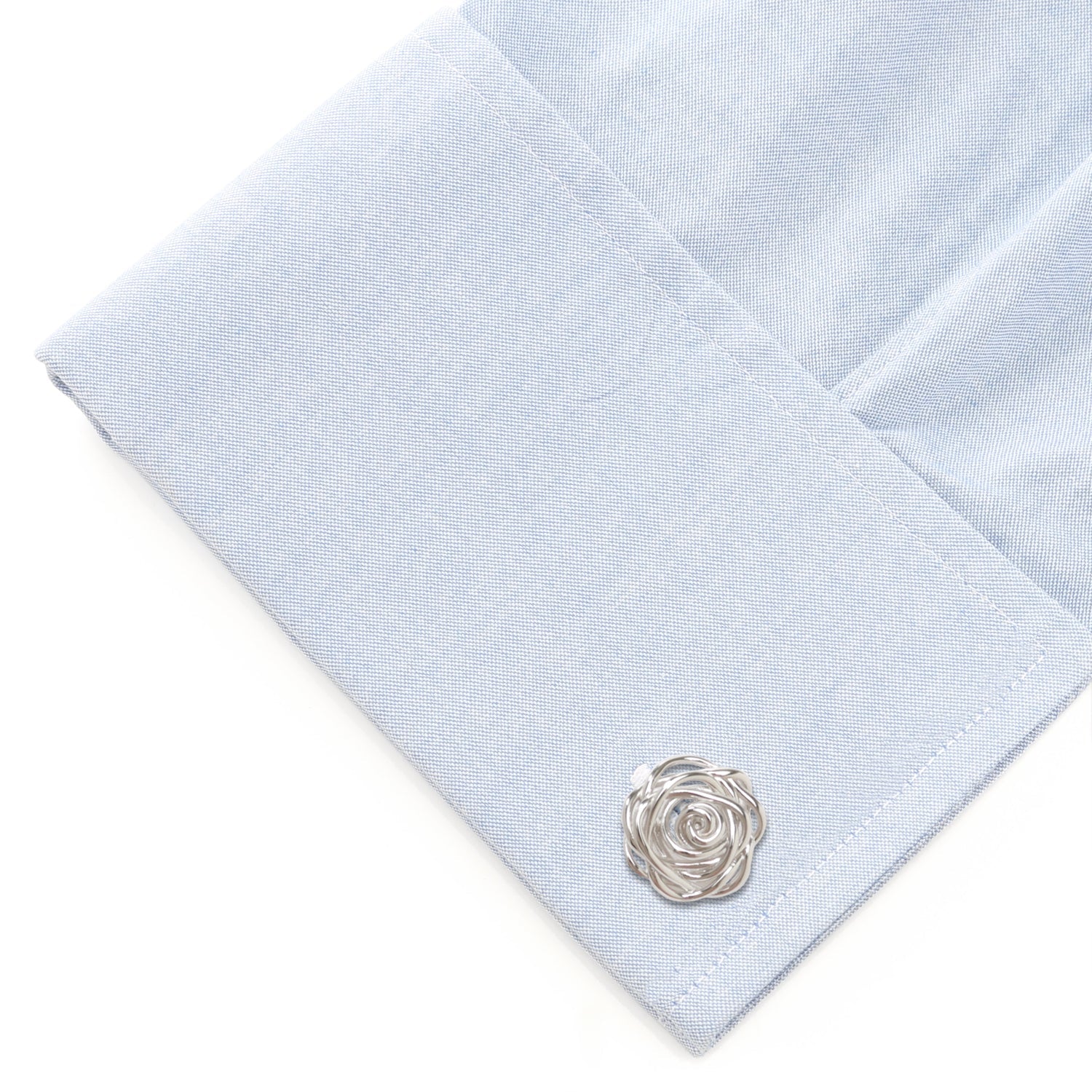 Light blue pocket square with a silver rose-shaped cufflink on a white background