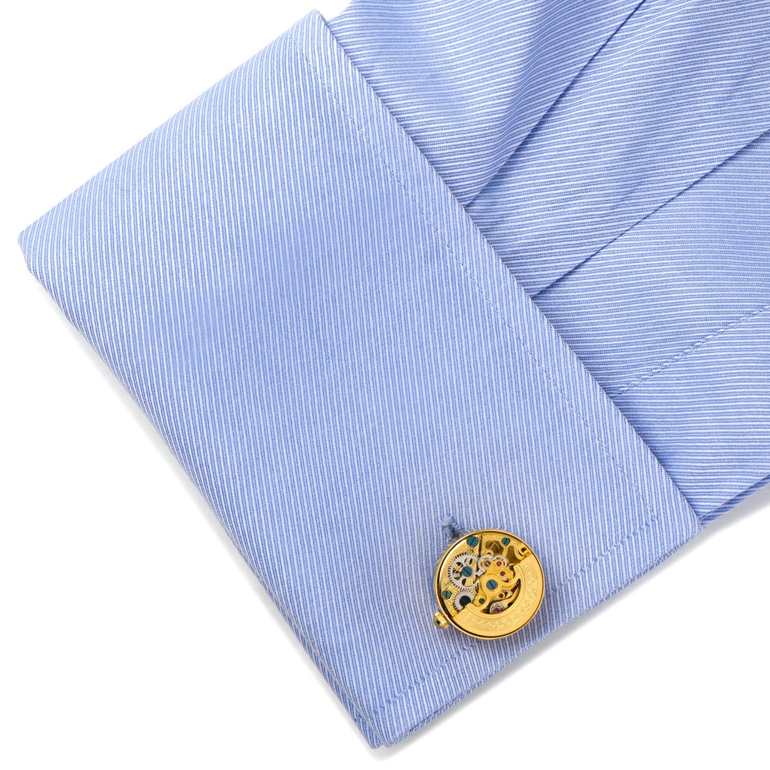 Gold cufflink on a light blue striped shirt