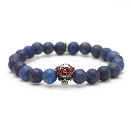Blue beaded bracelet with a skull charm on a white background