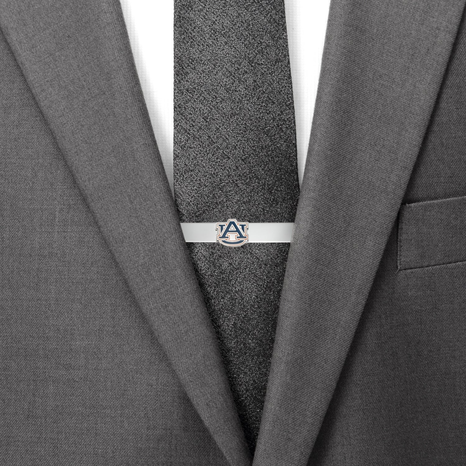 Gray suit jacket with a gray tie and a silver tie clip on a white background
