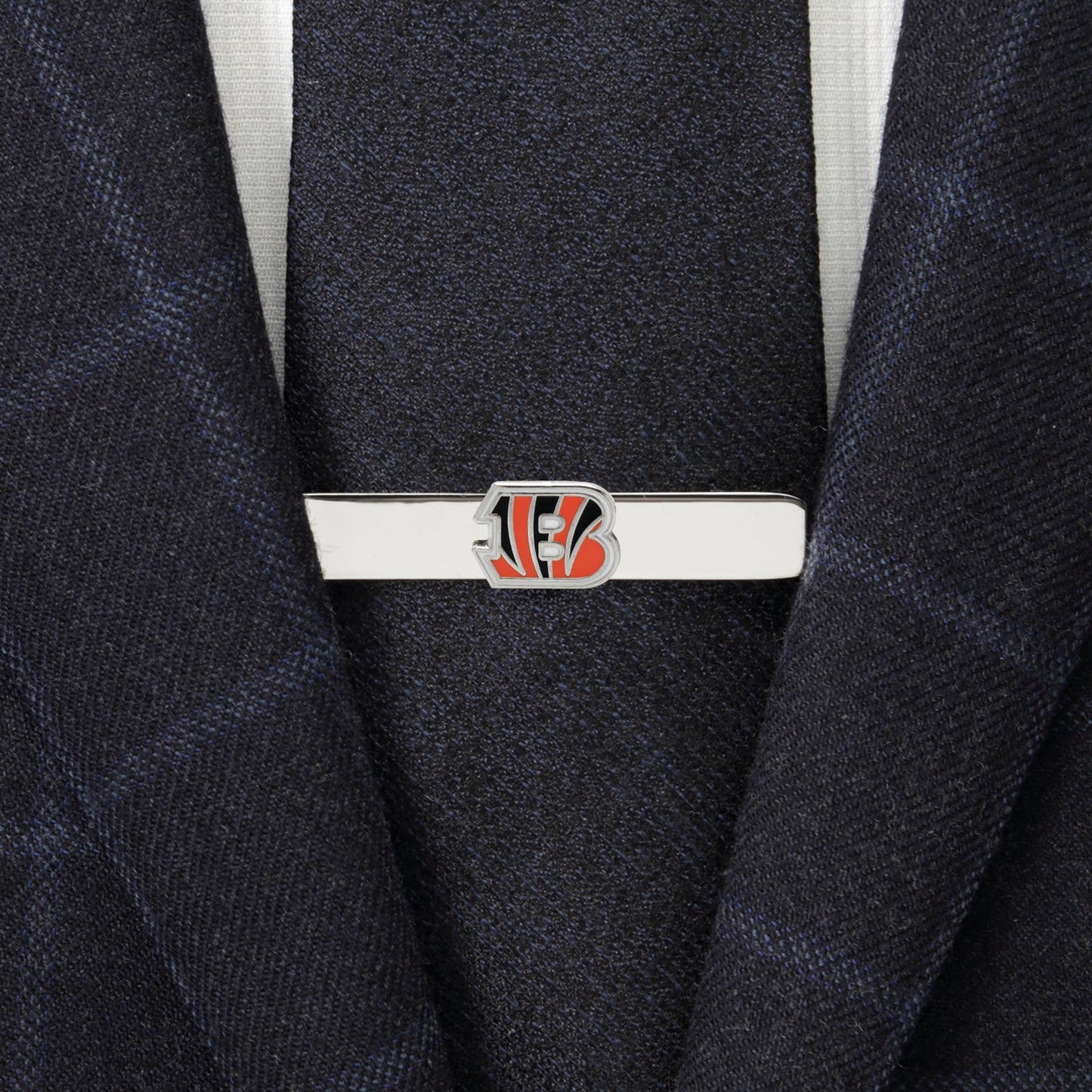 Tie clip with a logo on a suit jacket