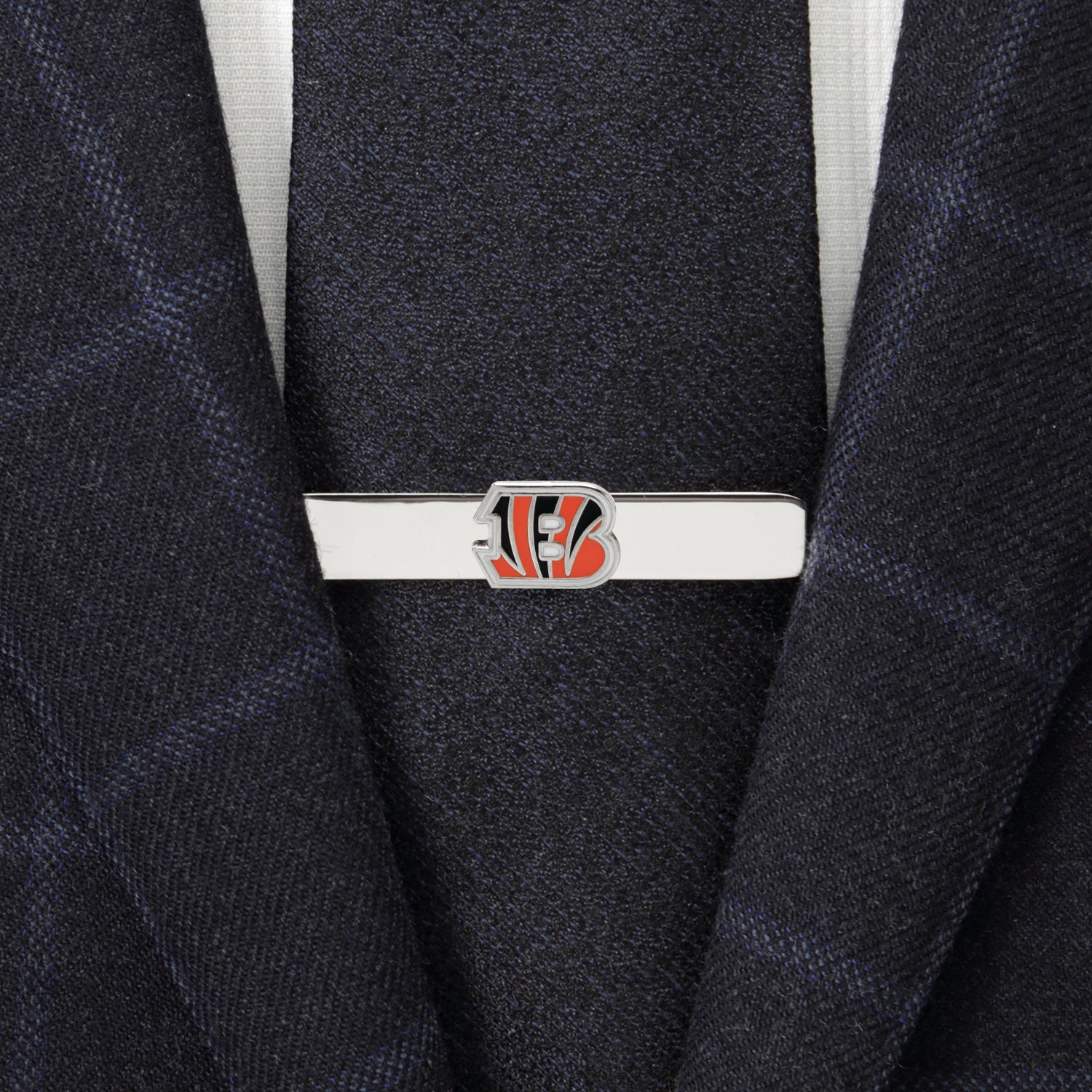 Tie clip with a logo on a suit jacket
