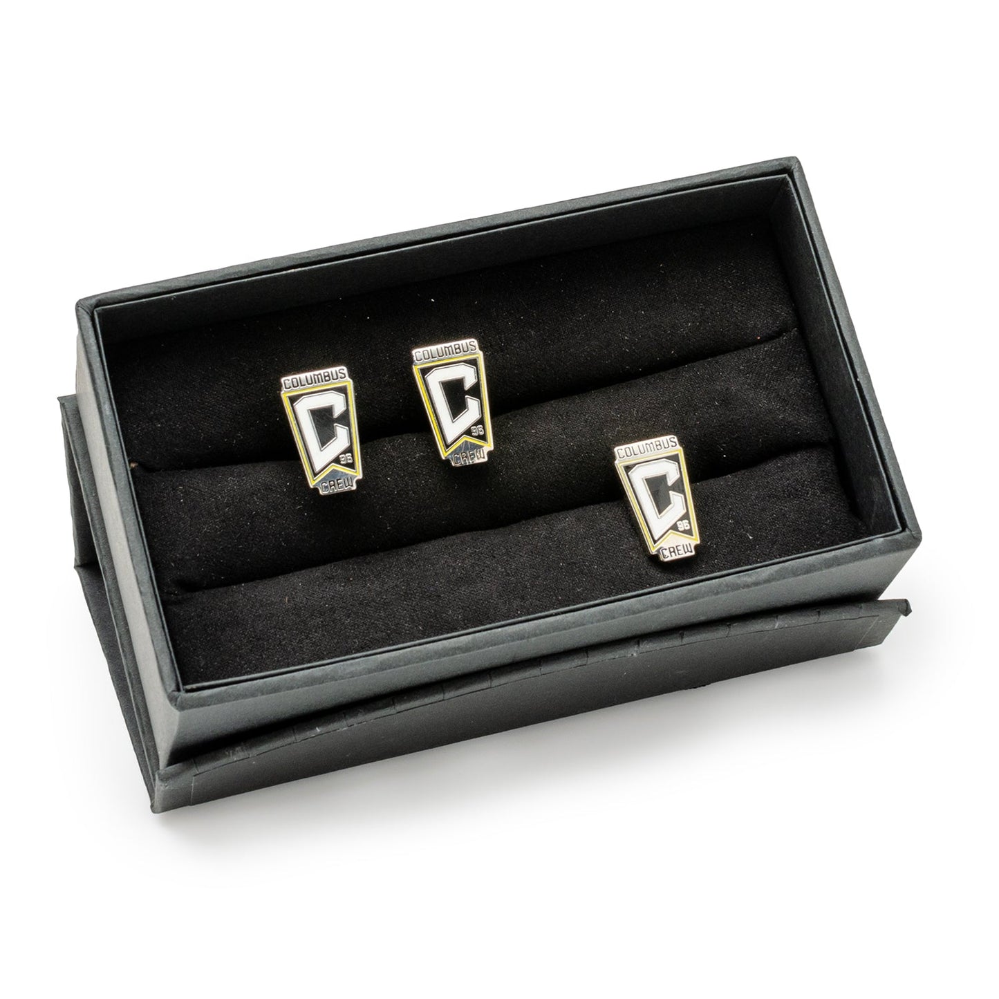 Three cufflinks in a black display box on a white background