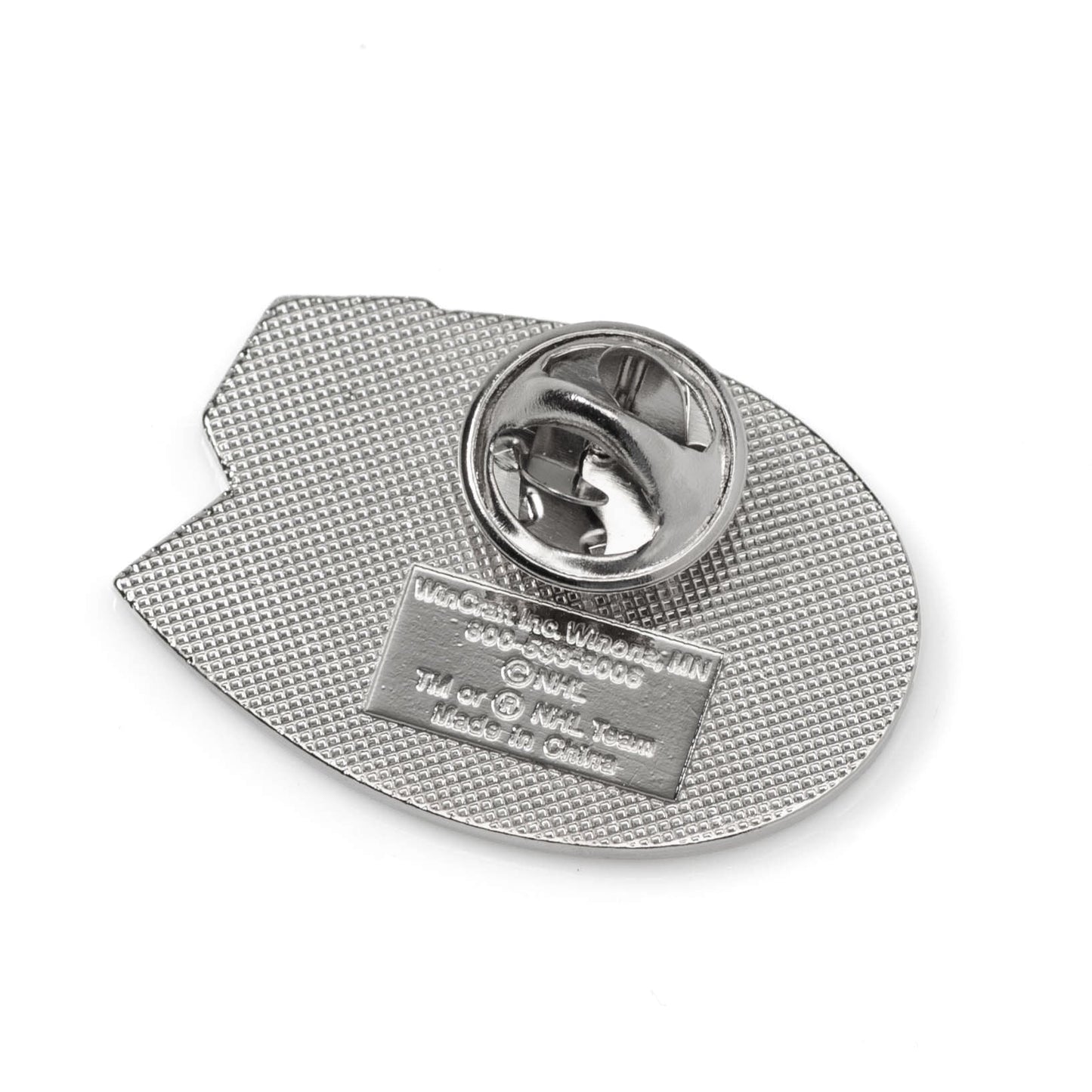 Metallic badge with textured back and brand name on a white background