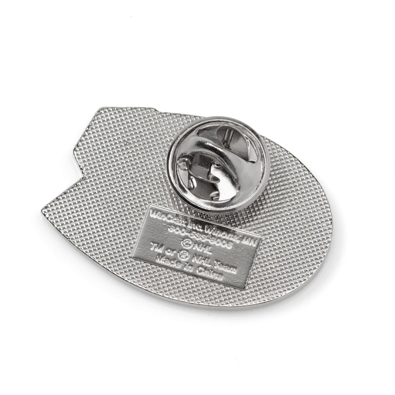 Metallic badge with textured back and brand name on a white background