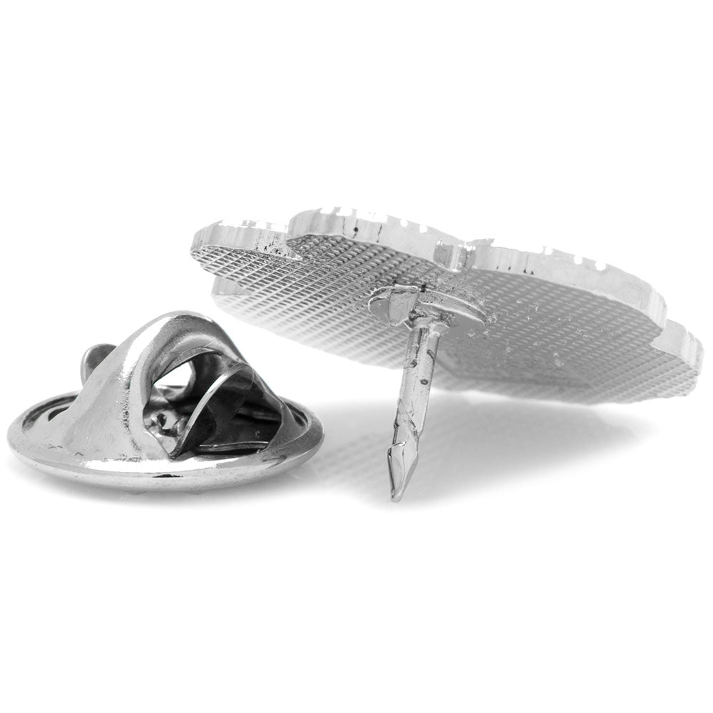 Metallic spaceship tie clip on a white background