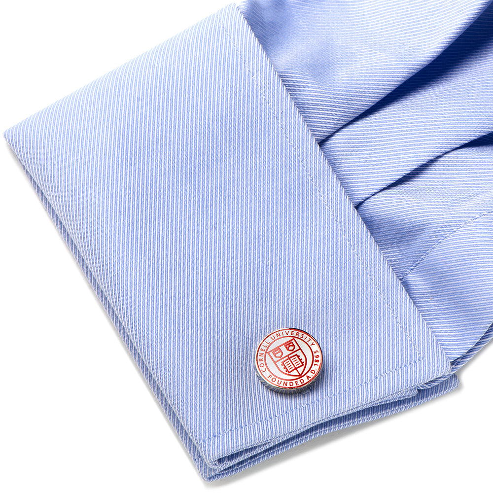 Close-up of a blue striped shirt with a cufflink on a white background
