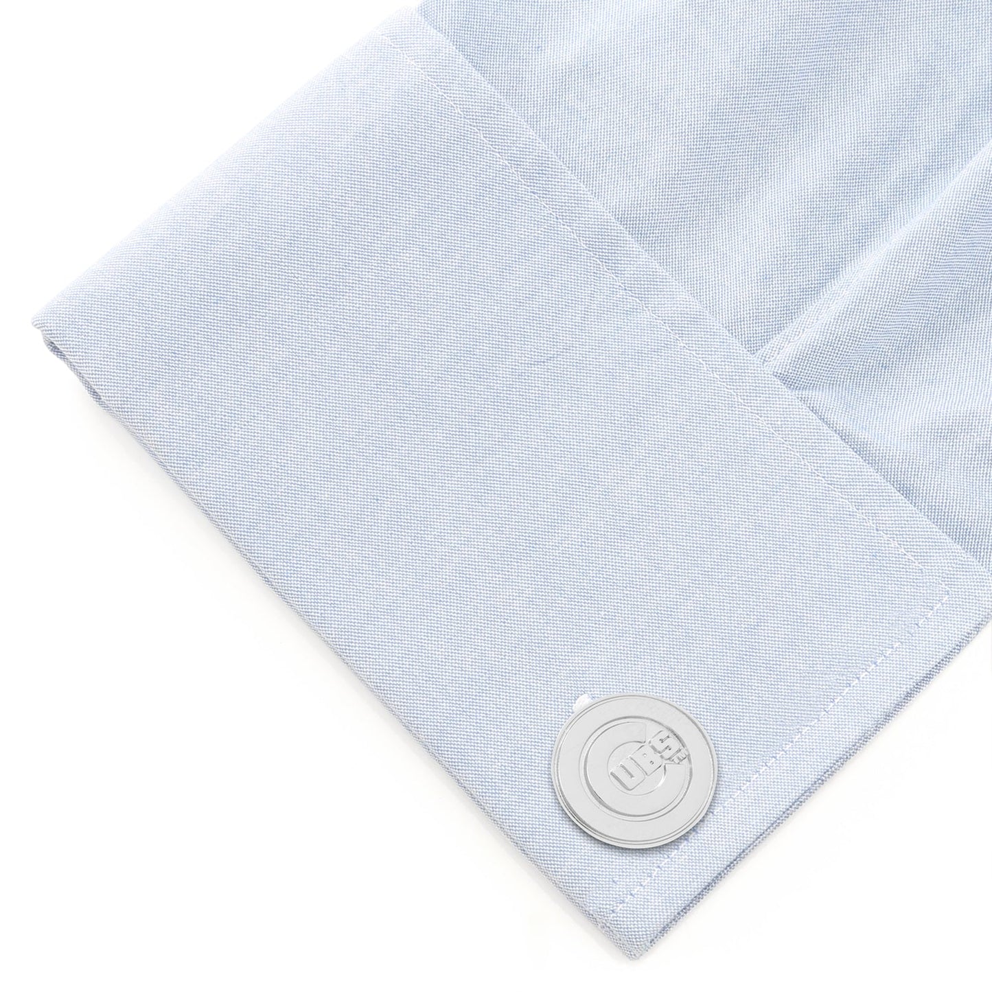 Light blue textured fabric with a silver button on a white background