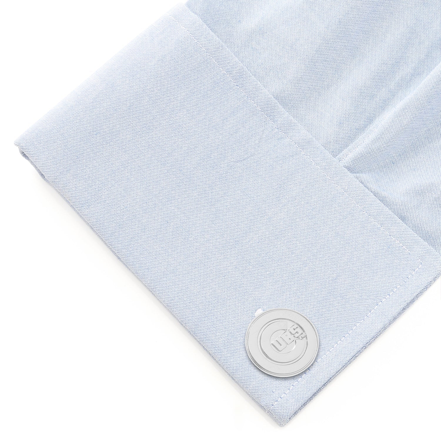 Light blue textured fabric with a silver button on a white background