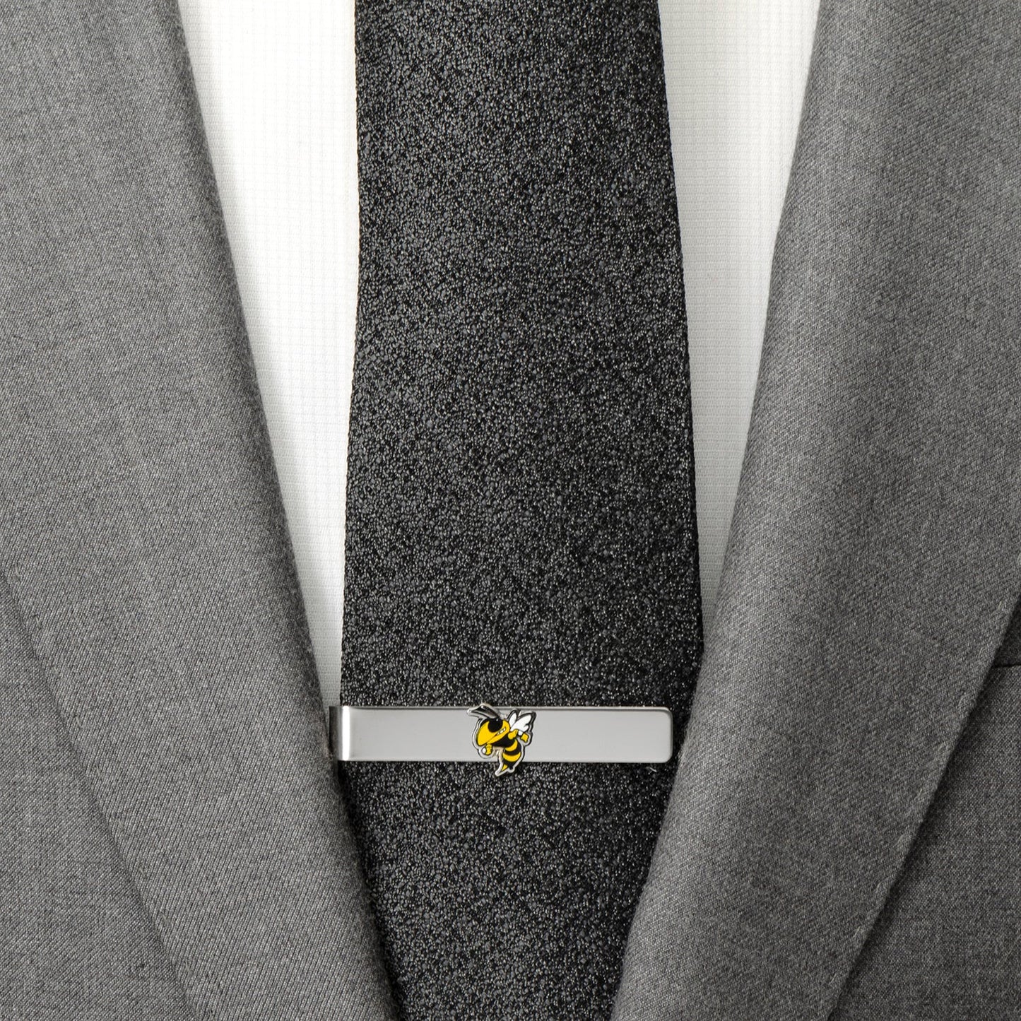 Gray suit with a black tie and silver tie clip featuring a yellow bee design.