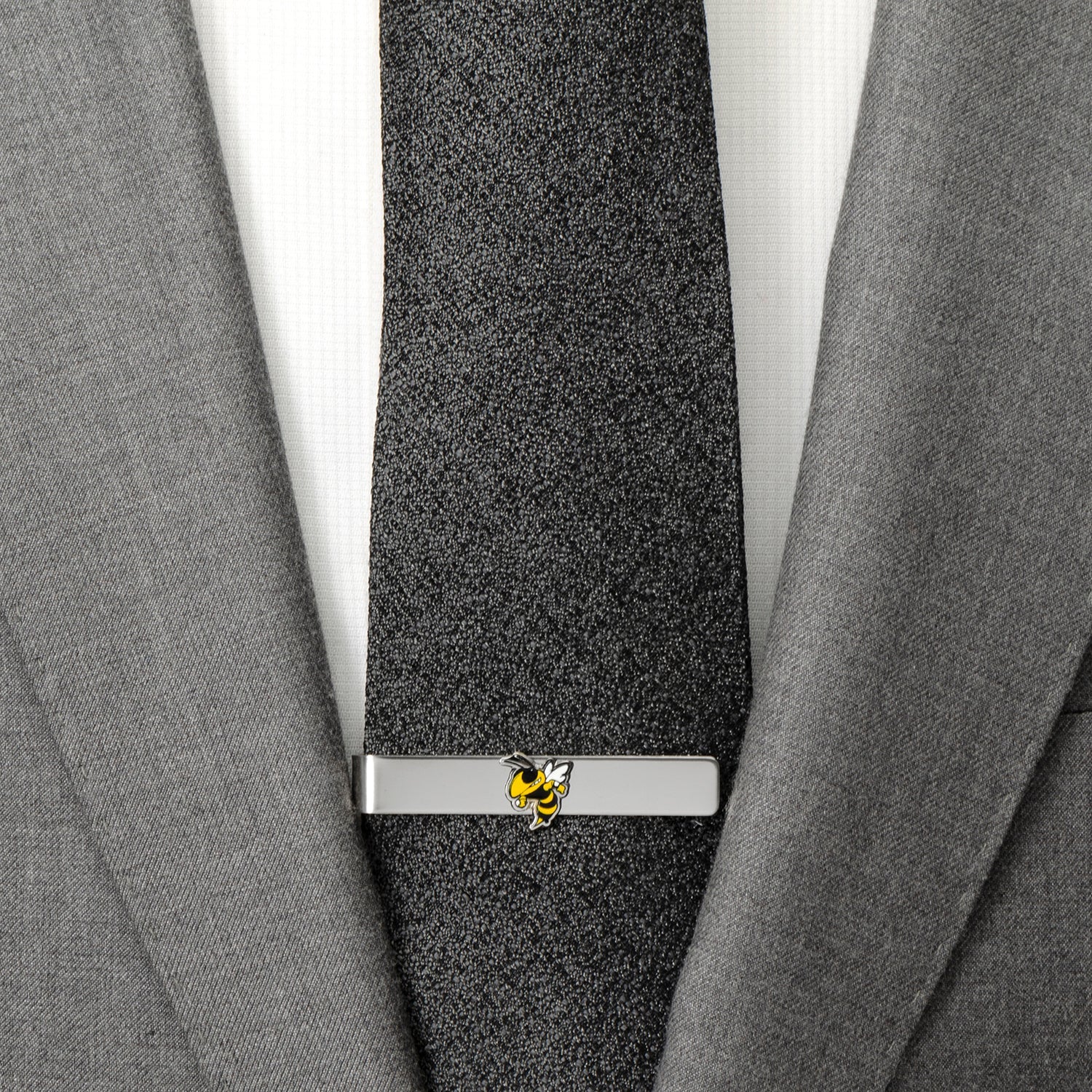 Gray suit with a black tie and silver tie clip featuring a yellow bee design.