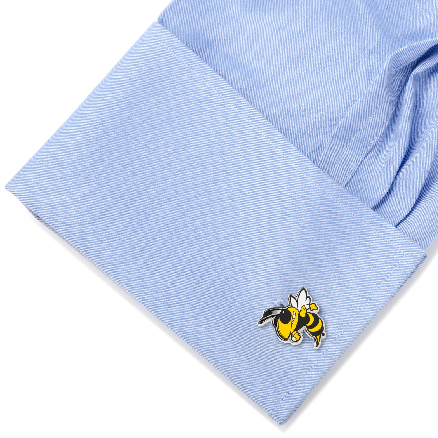 Cufflink with a bee design on a light blue shirt
